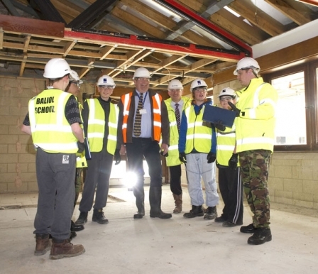 Students from Baliol School with their headteacher Drew Anderson (centre) give the thumbs up to building development work for their new school accompanied by Graham Nicol, Project Manager for Jacobs, (centre right) together with the two senior non commissioned officers in the Royal Engineers.