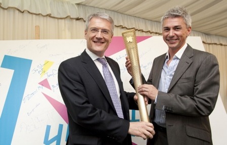 Photo Andrew Jones meets Olympic gold medallist Jonathon Edwards with the Olympic torch.