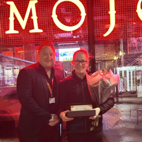 Charlotte Hogg receiving frontline hero award from Professional Security area manager David Bishop