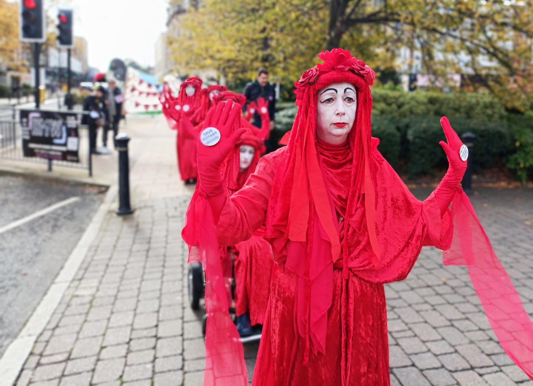 Extinction Rebellion’s Red Rebels Parade through Harrogate to Raise Awareness of the Threat to Rotary Wood from Danone and Harrogate Spring Water Proposed development