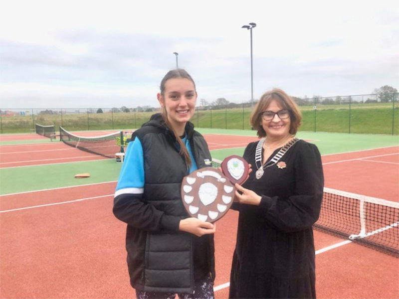 President Christine Anderson presenting the shield to Sofia Perez