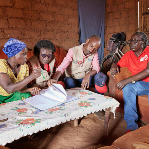 Aline Nibogora showing Christian Aid and its partners the VSLA account book in Burundi