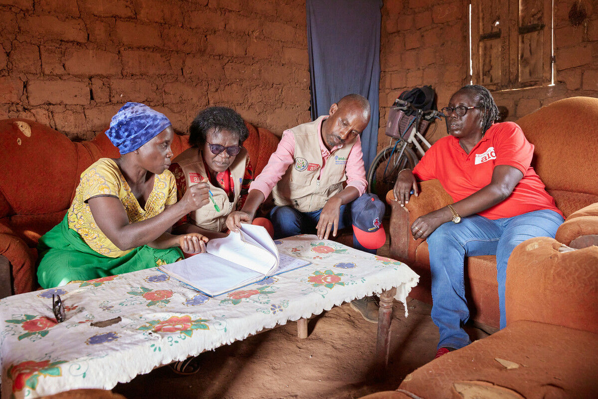 Aline Nibogora showing Christian Aid and its partners the VSLA account book in Burundi